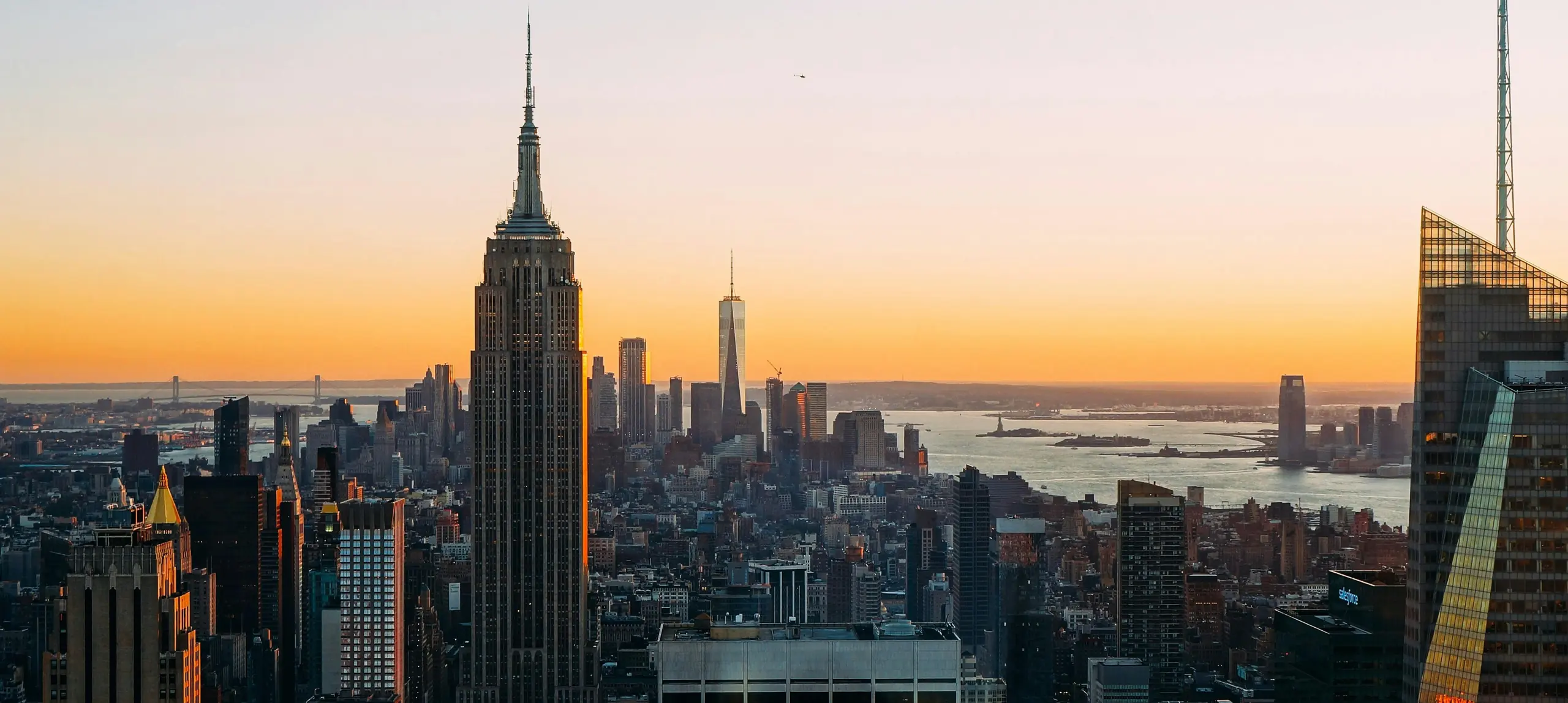 Midtown Manhattan at sunset, the Empire State Building above the harbour
